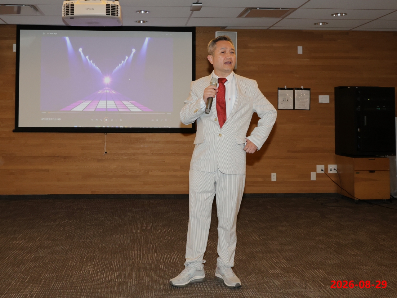Program host in a light-coloured suit